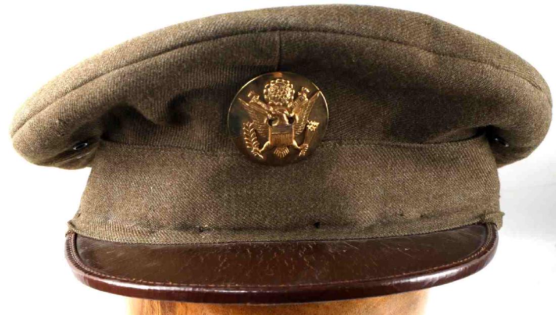 NAMED WWII US AMERICAN ARMY OFFICER VISOR CAP: WWII US Army officer's visor cap. Green wool construction with leather bill and cloth lining. Named on interior "R.G. Brower" in ink. Good condition overall with a few very small sections of mothing a