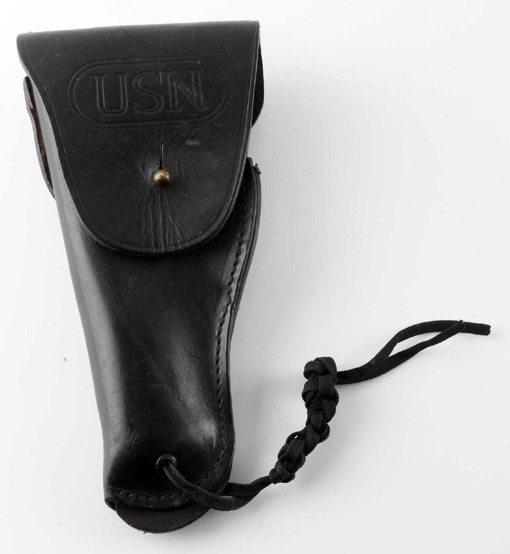 CATHEY ENTERPRISES US NAVY 9MM PISTOL HOLSTER: Vietnam era USN 9mm holster by Cathey Enterprises. Stitched leather construction and measures 10.75" in lenght. Marked "USN" on closure cap and "P/N (53711) 6086020 Cathey Enterprises Inc. 9mm LH" on 