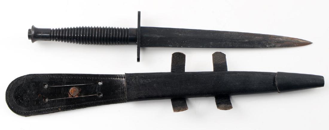 WWII BRITISH COMMANDO FS FIGHTING KNIFE W SHEATH: WWII British Commando F-S Fairbairn Sykes British Commando Replica fighting knife with black colored handle blade as well as black blade and leather scabbard with polished black metal locket. Item is 