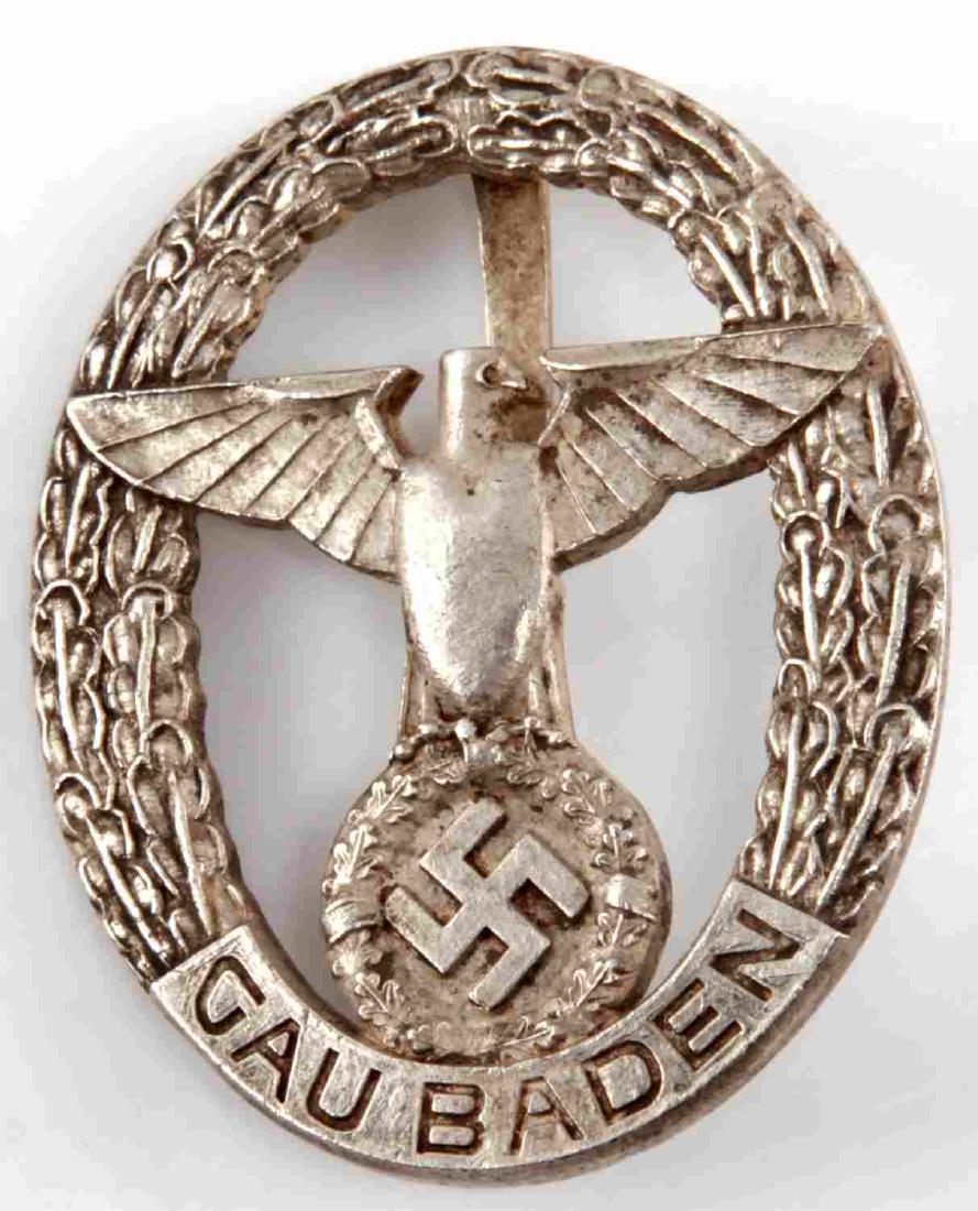GERMAN THIRD REICH GAU BADEN PARTEIADLER BADGE: Badge with a Parteiadler emblem with 'Gau Baden' written underneath. measures 1 3/4 inches by 1 1/4 inches. Reverse numbered '20'. In very good condition