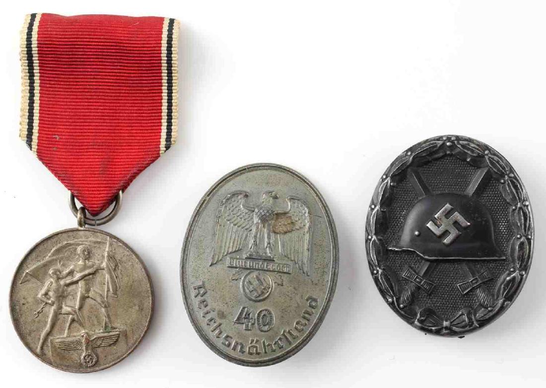 WWII GERMAN THIRD REICH BADGE & MEDAL LOT OF 3: This lot includes 1 black Condor Legion Wound badge, 1 Sudetenland medal, and 1 Reichsnährstand 40 year service badge. Good condition overall. Reichsnährstand badge is missing back pin.