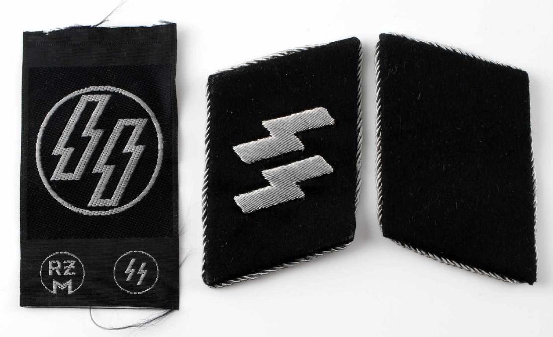 WWII GERMAN WAFFEN SS COLLAR TAB AND LABEL LOT: This lot includes 1 set (includes left and right) of SS Mann Type 1 - 1929-34 collar tabs and 1 SS RZM label. Very good condition overall. Collar tabs are of cloth and silver bullion wire construction