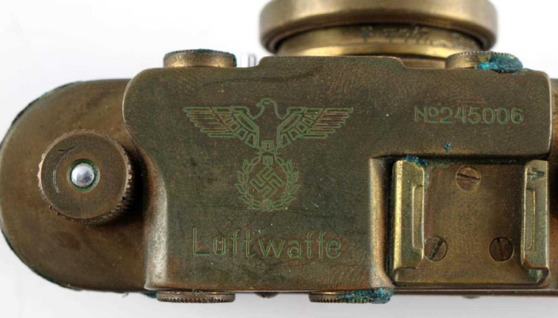 WWII GERMAN LUFTWAFFE 35MM SNAKESKIN CAMERA REPRO: German Luftwaffe Leica made 35mm camera. Brass and snakeskin construction with "Leica" engraved on its lens cover and Luftwaffe and Reichsadler at its top. Also engraved with the serial number: "No245