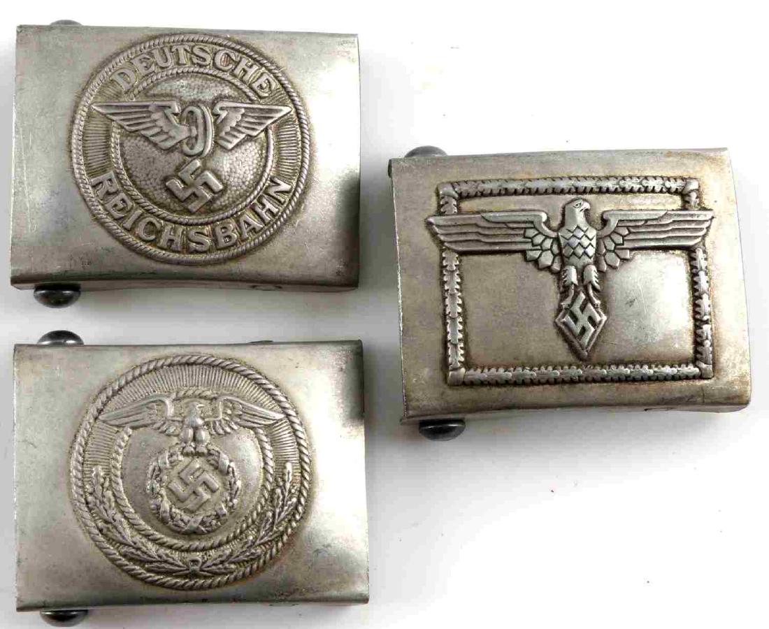 WWII GERMAN THIRD REICH BELT BUCKLE LOT OF 3: This lot features 3 German belt buckles including 1 SA buckle, 1 Hitler Jugend Leader buckle, and 1 Reichsbahn buckle. Each buckle is reverse RZM marked. Aluminum construction. Very good condition. Un