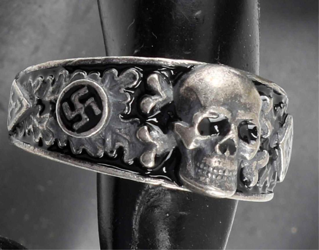 WWII GERMAN THIRD REICH SS AHNENERBE SILVER RING: German Ahnenerbe secret society silver ring. Has relief totenkopf at front of ring flanked by enameled swastika, oak leaves, and SS runes. Interior of ring engraved with Armanen runes. Marked 800 silv
