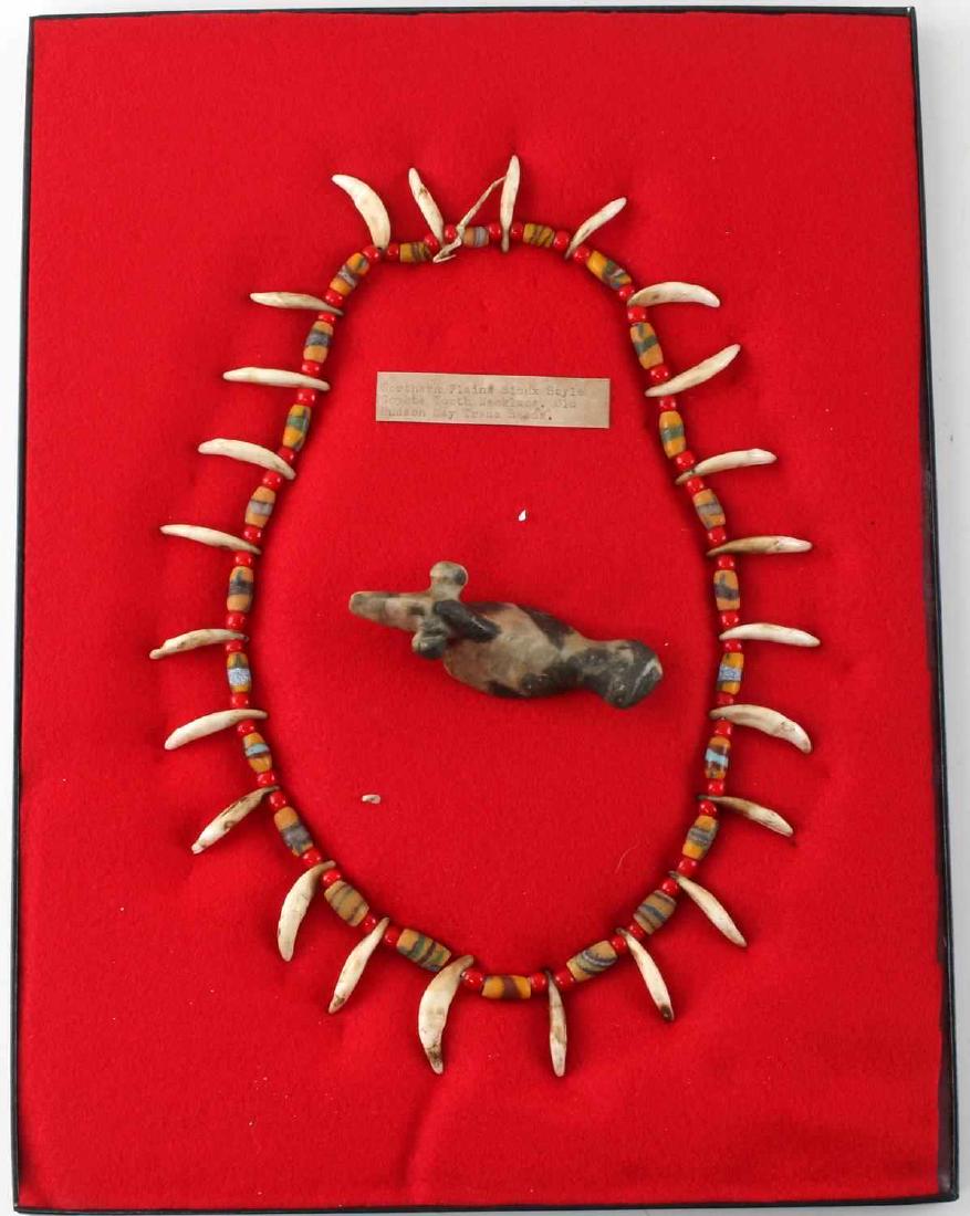 NATIVE AMERICAN TOOTH NECKLACE & POPEYED BIRDSTONE: This lot includes 1 Northern plains Sioux style coyote tooth trade bead necklace and 1 archaic - early woodland popeyed birdstone. Very good condition overall. Birdstone measures just over 4" in lengt