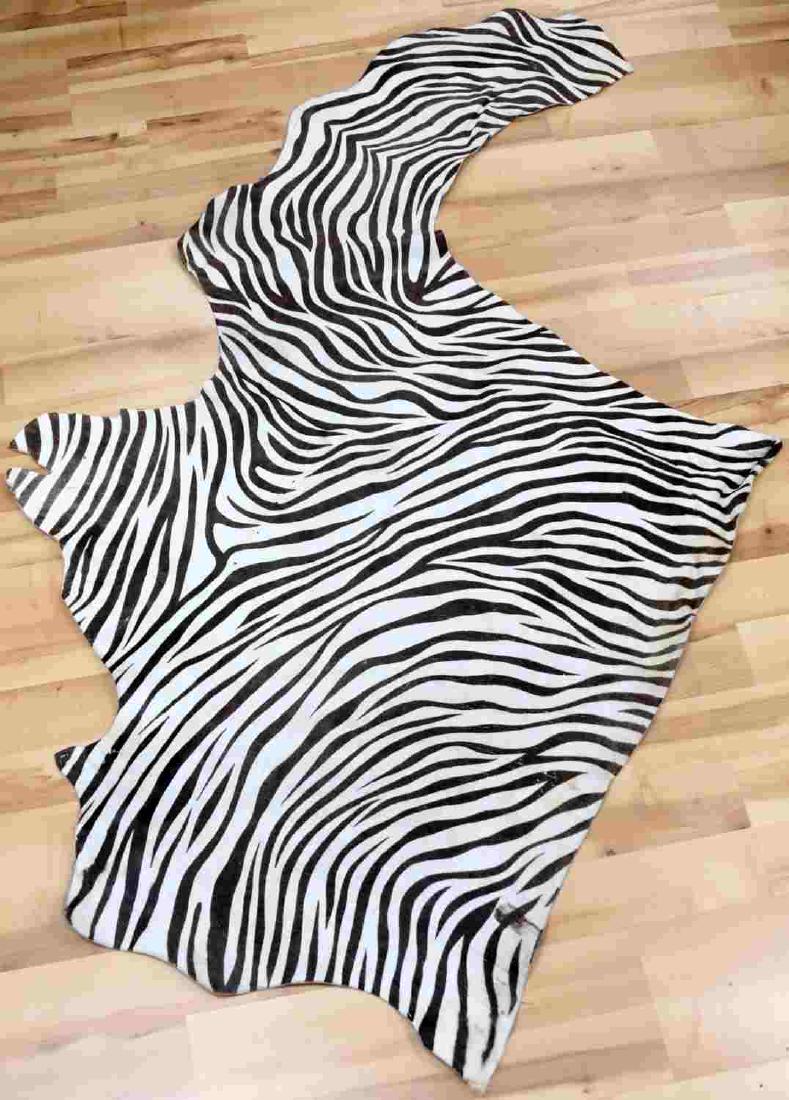 LARGE IRREGULARLY SHAPED PIECE OF ZEBRA SKIN: Skin measures approximately 74 inches by 34 inches. In good condition with what appears to be some areas of staining along small portion of edge. Unauthenticated. Sold as is. This lot has a reserve.