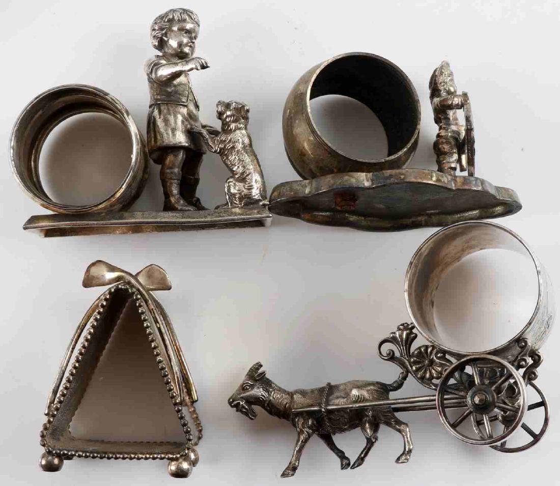 LOT 4 ANTIQUE SILVER PLATE DECORATIVE NAPKIN RINGS: Four Victorian silver plate ornate napkin rings. One tent shaped with incised "Best Wishes" on one side. Marked "Meridan Company 636" In very good condition. One with little boy playing with his dog.