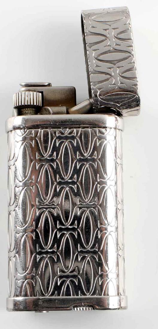 CARTIER GODRON DECOR PALLADIUM CIGARETTE LIGHTER: Cartier - France palladium plated Swiss made cigarette lighter, with engraved "Godron" monogram pattern. Serial No. 258155.