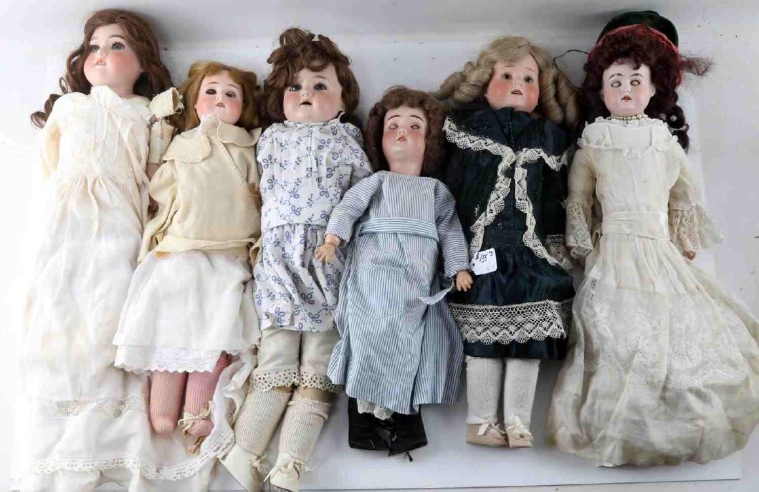 6 GERMAN ANTIQUE BISQUE HEADED PORCELAIN DOLLS: One Schoenau & Hoffmeister doll. Long blonde hair, sleep eyes, open mouth and wearing cream colored cotton dress with coat. Cloth jointed composition body. Marked "SH BP" with star on back. Measures 1