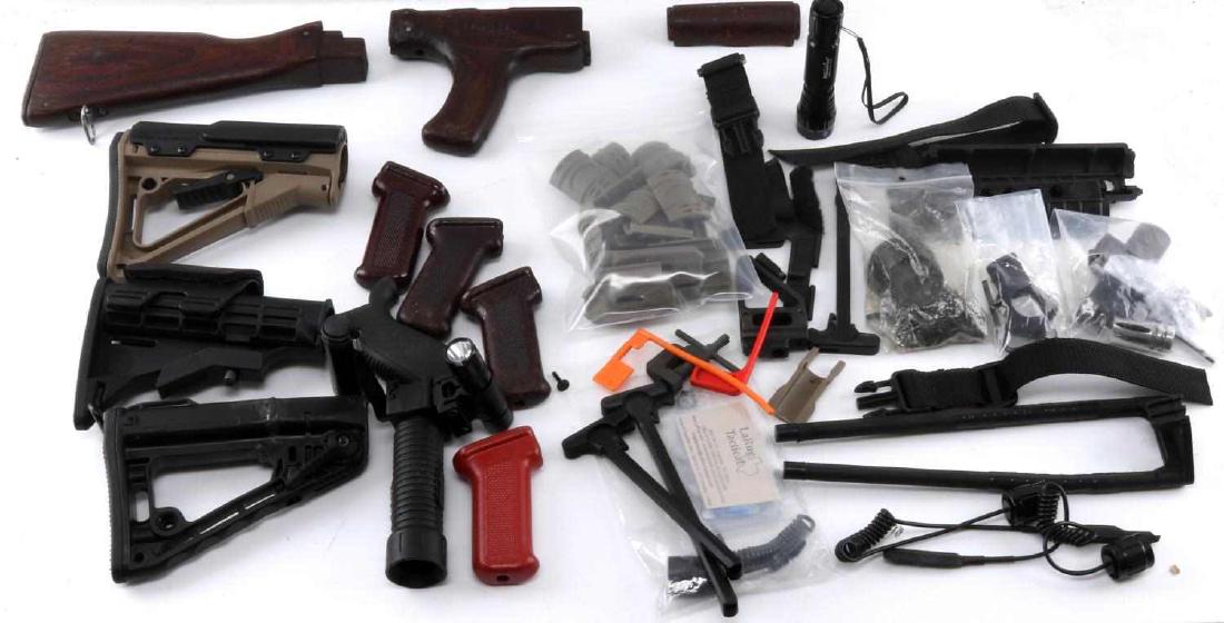 LARGE LOT OT AR AND AK RIFLE PARTS STOCKS FORE ARM: Good collection of rifle stocks fore arms, Ruger, Rogers (repaired), Risr and others, includes a mounted light forearm, muzzle break, ejection port dust cover, Sight post, charging handles and other m