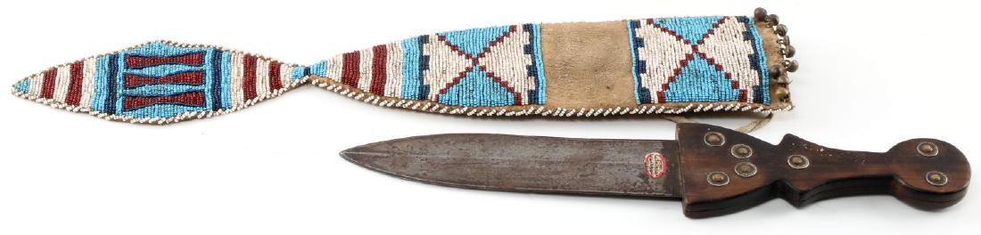 NATIVE AMERICAN 1800S DAG KNIFE & BEADED SHEATH: 19th century Native American Dag knife. Shaped wooden handle with silver rivets and double edged heavy darkened steel blade. 19" long with a 12" blade. Comes with beaded hide sheath. Good condition fo