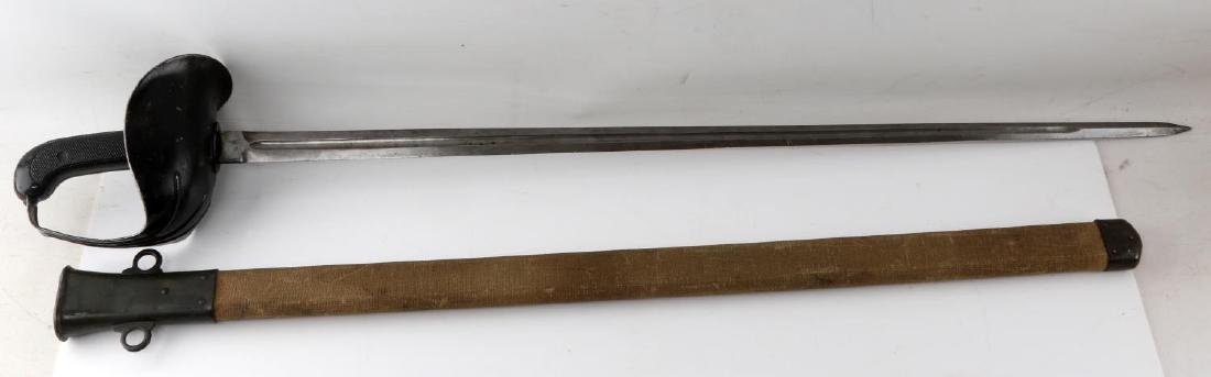 MODEL 1913 US PATTON CAVALRY SWORD DATED 1918: A Model 1913 "Patton" cavalry sword. Includes canvas scabbard. LF&CO manufacturer mark on the ricasso. Minor paint wear on both the hilt and throat of scabbard. Blade has some discoloration and minor 