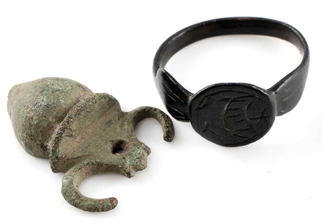 EXCAVATED CELTIC AMULET & VIKING RING LOT: This lot includes 1 rare 200 BC Celtic Amulet and 1 Viking ring. Ring has engraved boat at front and was excavated in Ukraine. Amulet was excavated in Bosnia. Very good overall. Amulet measures 1" in 