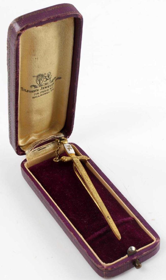KNIGHTS OF COLUMBUS FRATERNAL SWORD STICK PIN: Gilded stick pin measuring approximately 3 1/4 inches in length and showing the Knights of Columbus sword with the Knight's head pommel. Has a cloisonne grip plate on the obverse with the Knights of C