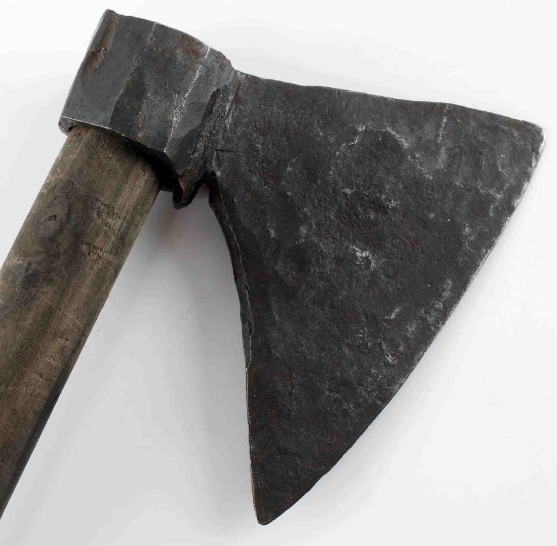 ANTIQUE POSSIBLY MEDIEVAL CAVALRY BATTLE AXE: Battle axe with a head which is believed to be antique, possibly late Middle Ages in origin. Metal shows signs of having been blacksmith forged. Shaft is a more recent replacement. Brass ball cap on t