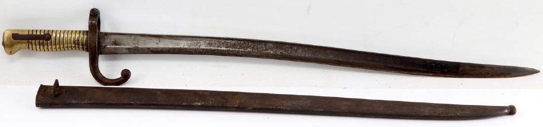 M1874 CHASSEPOT ETIENNE GRAS BAYONET W SCABBARD: Model 1874 Chassepot Yataghan Rifle bayonet with marked blade ricasso, blade spine which has the date "1874 Etienne Gras" & maker marking ; as well as various hall markings on the crossguard of the ba