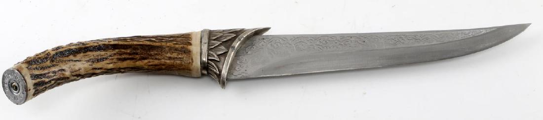 GERMAN STYLE ETCHED HUNTING KNIFE WITH 12GA POMMEL: German style etched hunting knife with 12 gauge REMINGTON centerfire metallic ring affixed to the end of the horn handle as its pommel. Stag horn handle measures 5 inches while etched blade measures 8