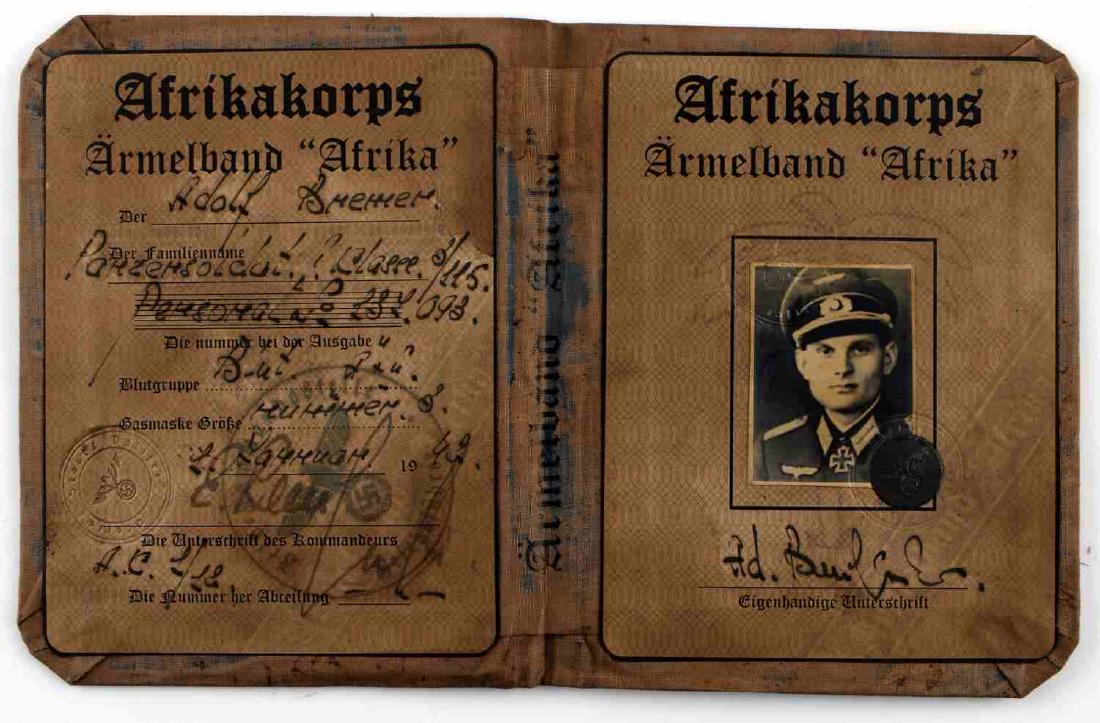 WWII GERMAN NSDAP AFRIKAKORPS AUSWEIS ID CARD: Ausweis ID is dated 1943 and named to Adolf Brenner with photo, handwritten Panzersoldat denoting panzer duty, complete with frontal AfrikaKorps sigil of Swastika in front of the palm tree. Unauthenti