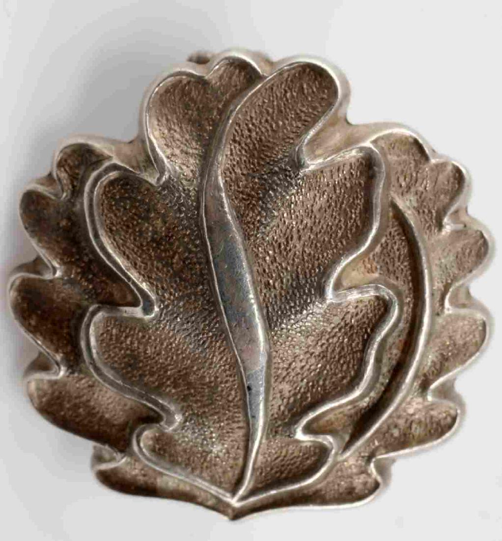 WWII GERMAN OAK LEAVES TO THE KNIGHTS CROSS: Oak leaves to the Knights Cross. Marked 800 silver and "20" on its reverse. Shows real age and patina and tests positive for silver content. Very good condition overall. Unauthenticated; sold as is.