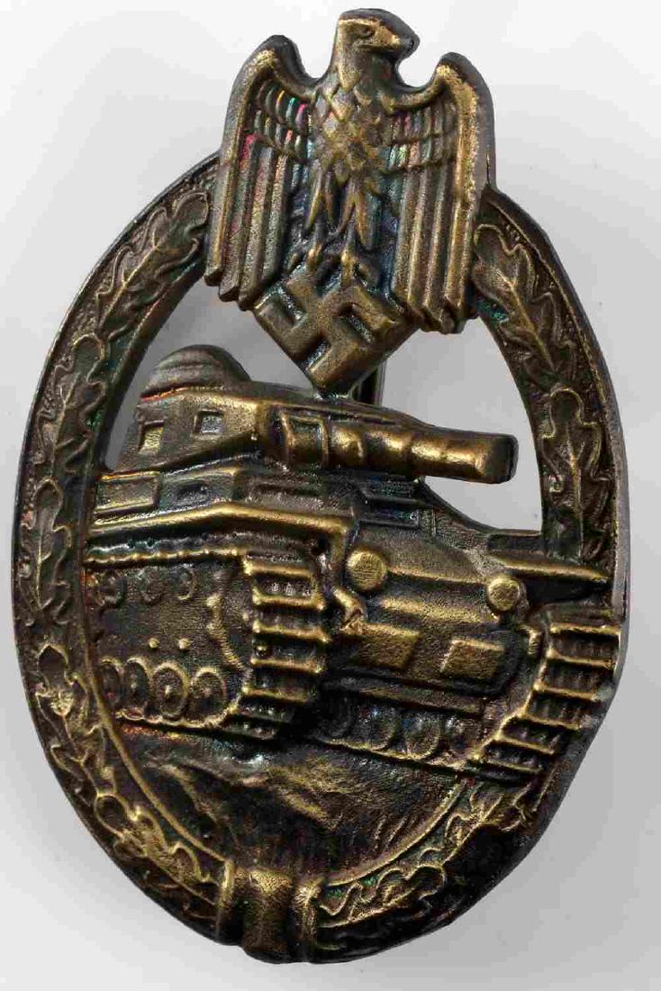 WWII GERMAN THIRD REICH PANZER ASSAULT BADGE: German Panzer Assault badge in bronze. Reverse maker mark by F.W. Assman. Solid back construction with vertical pin back. Very good condition with light patina and slight detail loss present. Unauthen