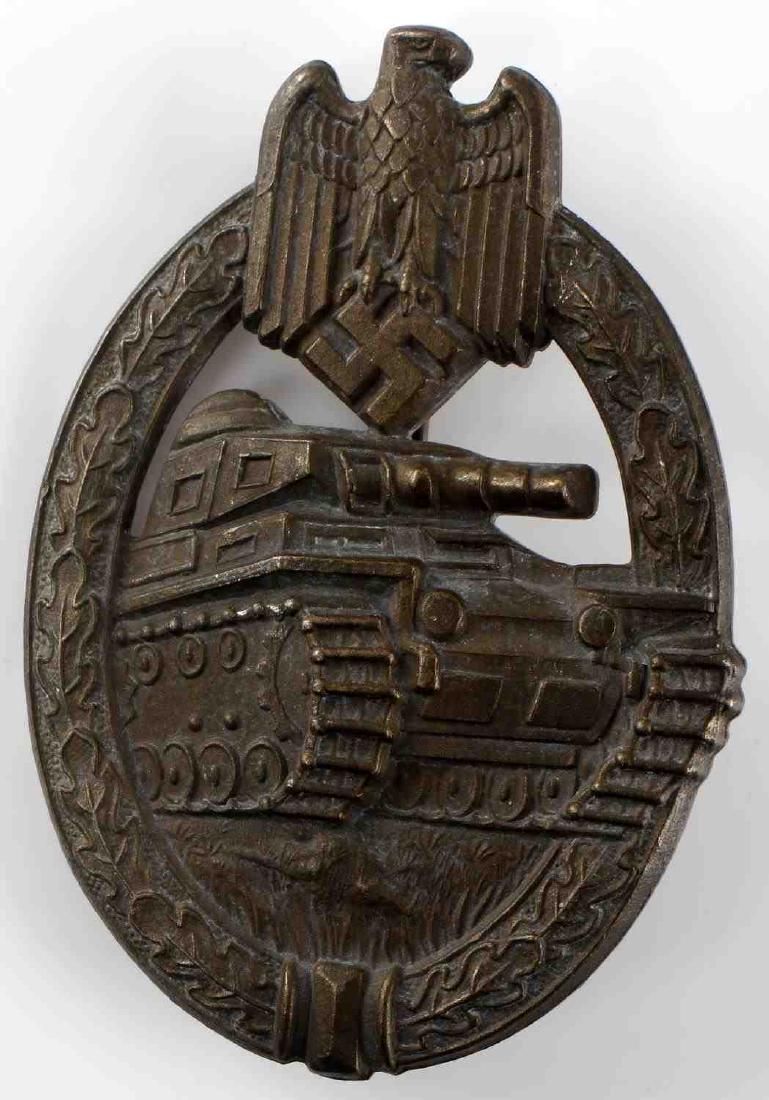WWII GERMAN THIRD REICH PANZER ASSAULT BADGE: German Panzer Assault badge in bronze. Solid-back construction with thing vertical reverse pin. Maker marked "HA" for Herman Aurich. Very good condition overall. Some patina and very slight detail los