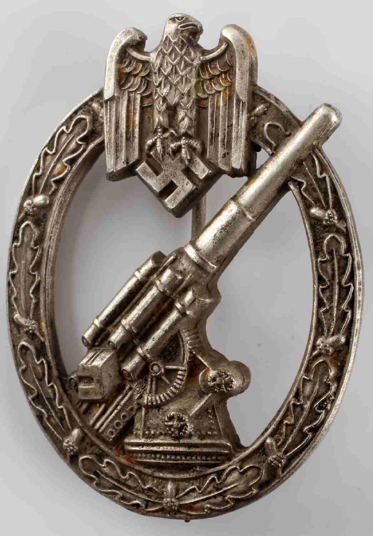 WWII GERMAN 3RD REICH HEER ANTIAIRCRAFT FLAK BADGE: German Heer Flak badge. Solid back construction with thing vertical pin. Maker marked with stylized A for Assmann. Very good condition with some patina present.