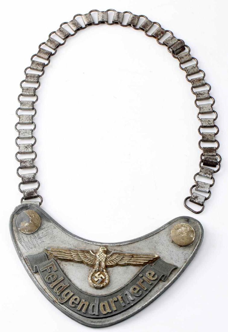 WWII GERMAN THIRD REICH FELDGENDARMERIE GORGET: German Feldgendarmerie gorget. Aluminum construction with "Feldgendarmerie" and Reichsadler to front. Remnants of fluorescent paint still visible. 1 rear uniform hook is broken and a possible repair m