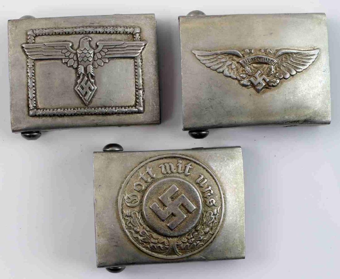 WWII GERMAN THIRD REICH BELT BUCKLE LOT OF THREE: Lot contains three German belt buckles. Includes Hitlerjugend, Luftschutz, and police. All have RZM marks. In very good condition. Unauthenticated/Sold 'as is' This lot has a reserve.