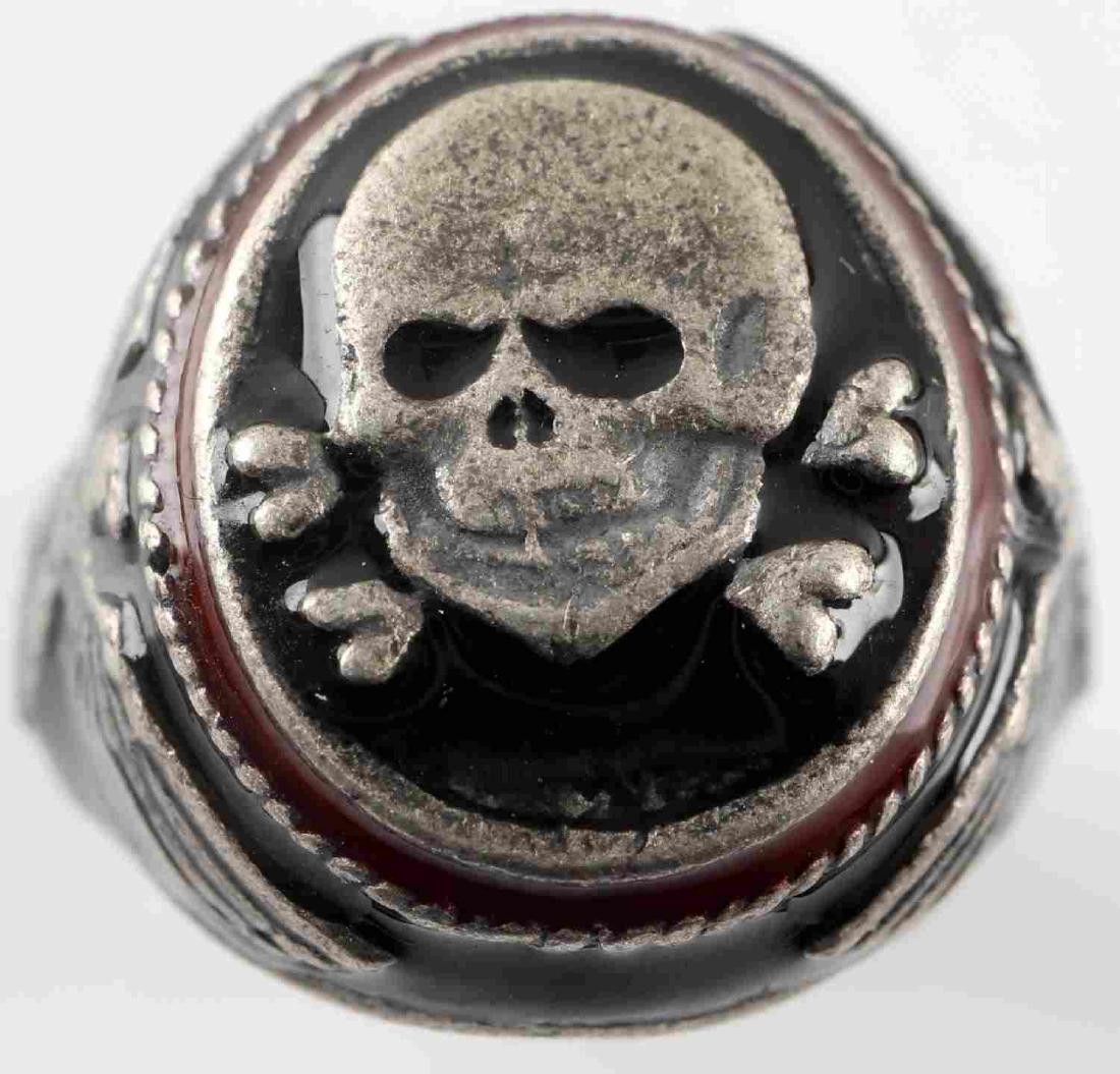 WWII GERMAN THIRD REICH SS TOTENKOPF SILVER RING: Silver ring with a large central Totenkopf flanked by a pair of Reichsadlers. Has 800 silver mark. Weighs 13.3 grams. In very good condition. Unauthenticated/Sold 'as is' This lot has a reserve.