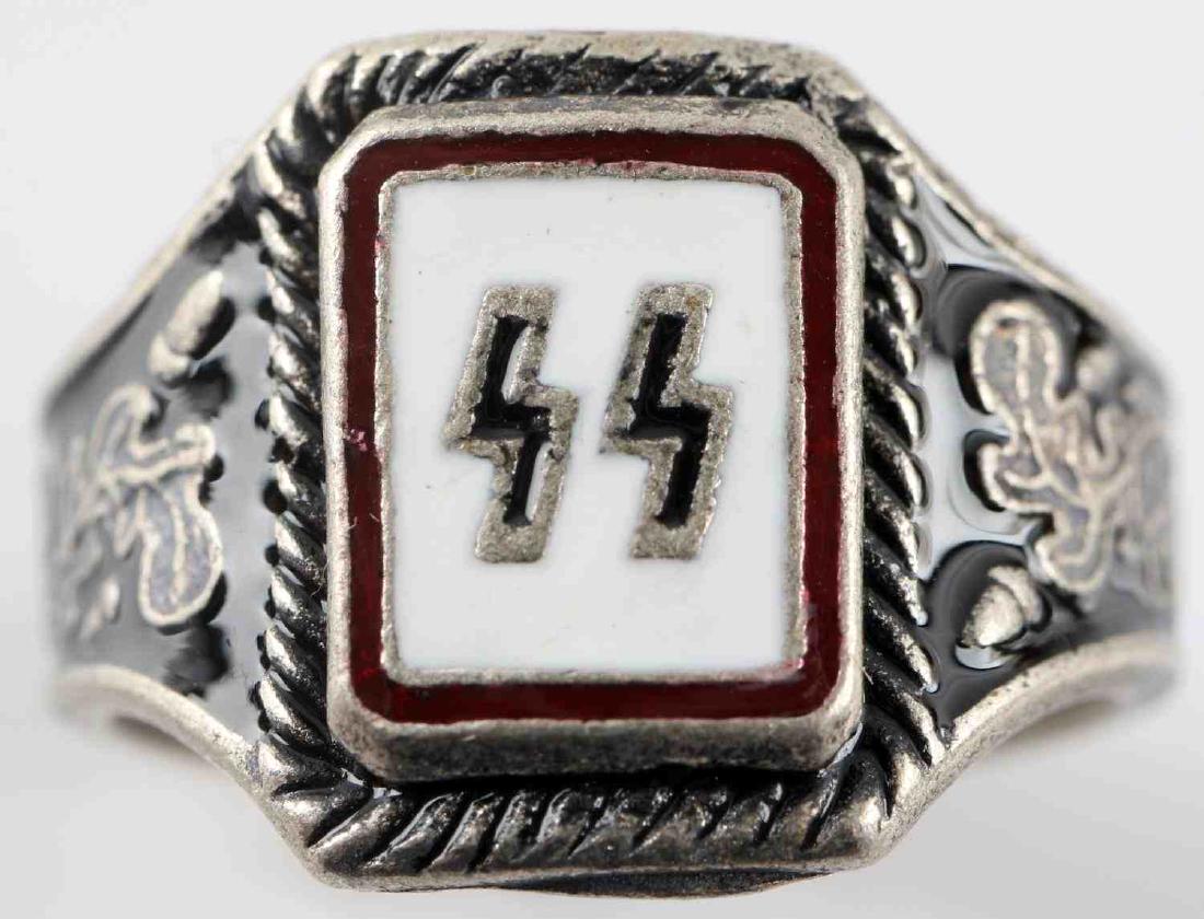 WWII GERMAN THIRD REICH WAFFEN SS SILVER RING: Silver ring with black and silver SS runes surrounded by white enamel and flanked by oak leaves. Weighs 6.9 grams. Has 800 silver mark. In very good condition. Unauthenticated/Sold 'as is'. This lot h