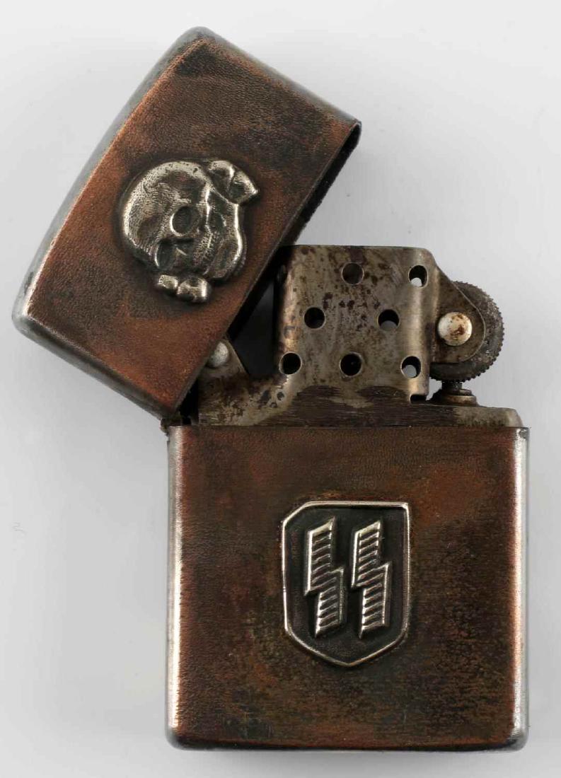 WWII GERMAN 3RD REICH WAFFEN SS CIGARETTE LIGHTER: German Zippo style lighter with affixed Totenkopf and double S sig runes. Lighter is also RZM stamped at its bottom. Good condition overall with some corrosion and discoloration present. Unauthenticat