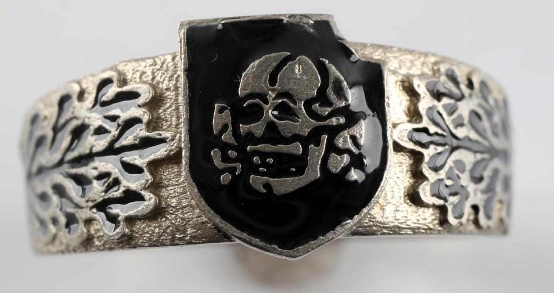 WWII GERMAN THIRD REICH SS TOTENKOPF SILVER RING: Silver ring with the emblem of the SS Totenkopf division in the center. Weighs 5.3 grams. Back is engraved with "Totenkopf" in black enamel. Inside has facsimile of Himmler's signature. Has 800 silver