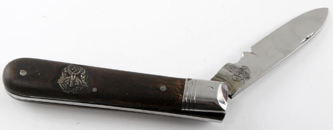 WWII GERMAN POLICE SOLINGEN POCKET FOLDING KNIFE: German Police pocket knife with affixed police Reichsadler on handle and WKC knight motif on blade. Single blade knife. Very good condition overall. Some wood wear present. This lot has a reserve.