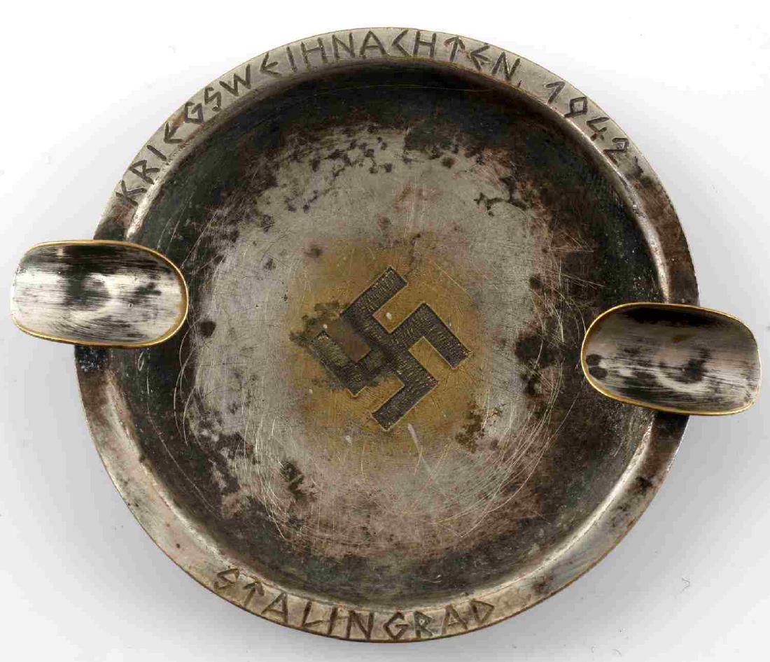 WWII GERMAN 3RD REICH BATTLE OF STALINGRAD ASHTRAY: German Battle of Stalingrad trench art ashtray. Has engraved swastika and "Stalingrad 1942" on its rim. Good condition overall. Some tarnishing and signs of use present. Measures 2.5" in diameter. Una