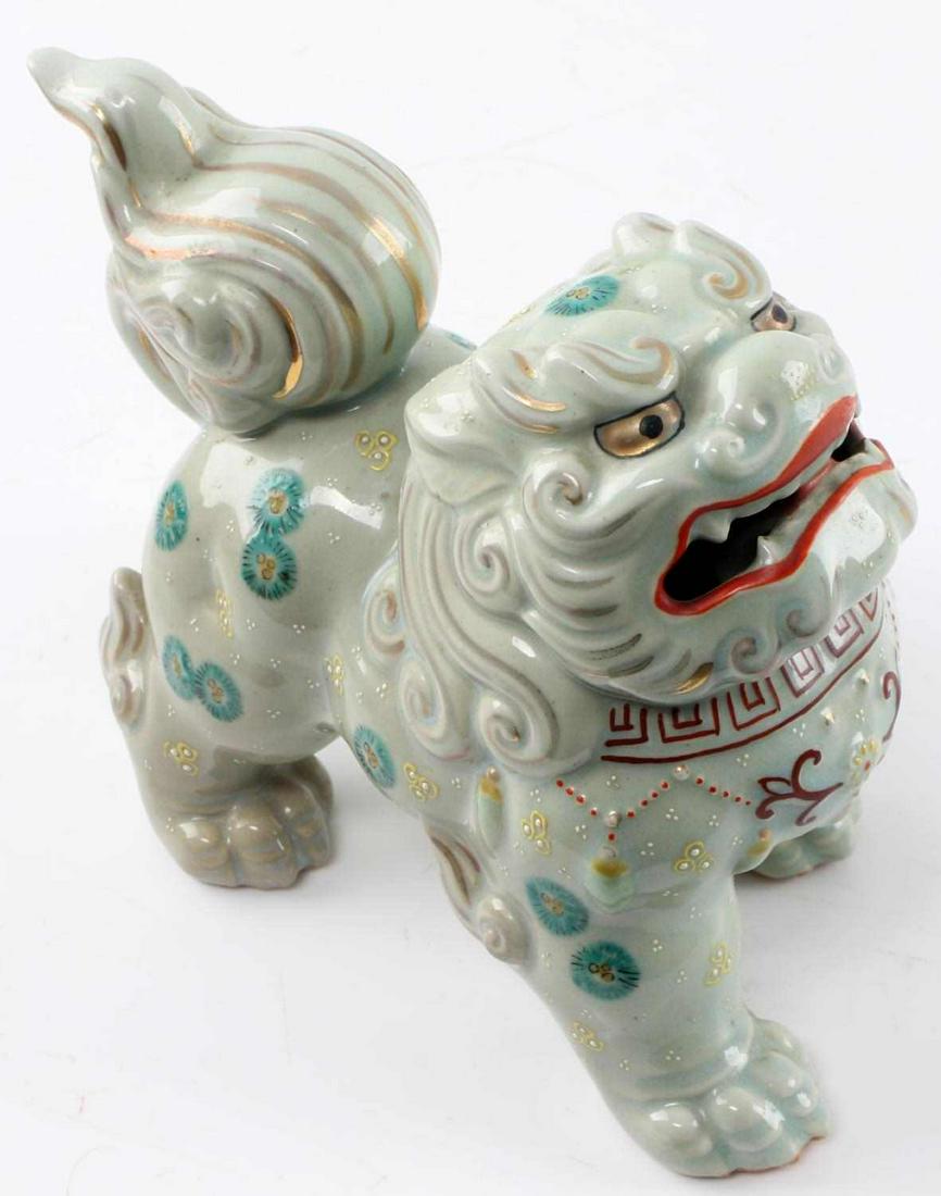 MEIJI PERIOD JAPANESE KUTANI PORCELAIN FOO DOG: Large 6" X 8" X 3.5" Meiji period Kutani celadon moriage porcelain shishi foo dog. Hand painted and adorned with 24k gold highlights. Excellent condition. Small signs of wear present to feet.
