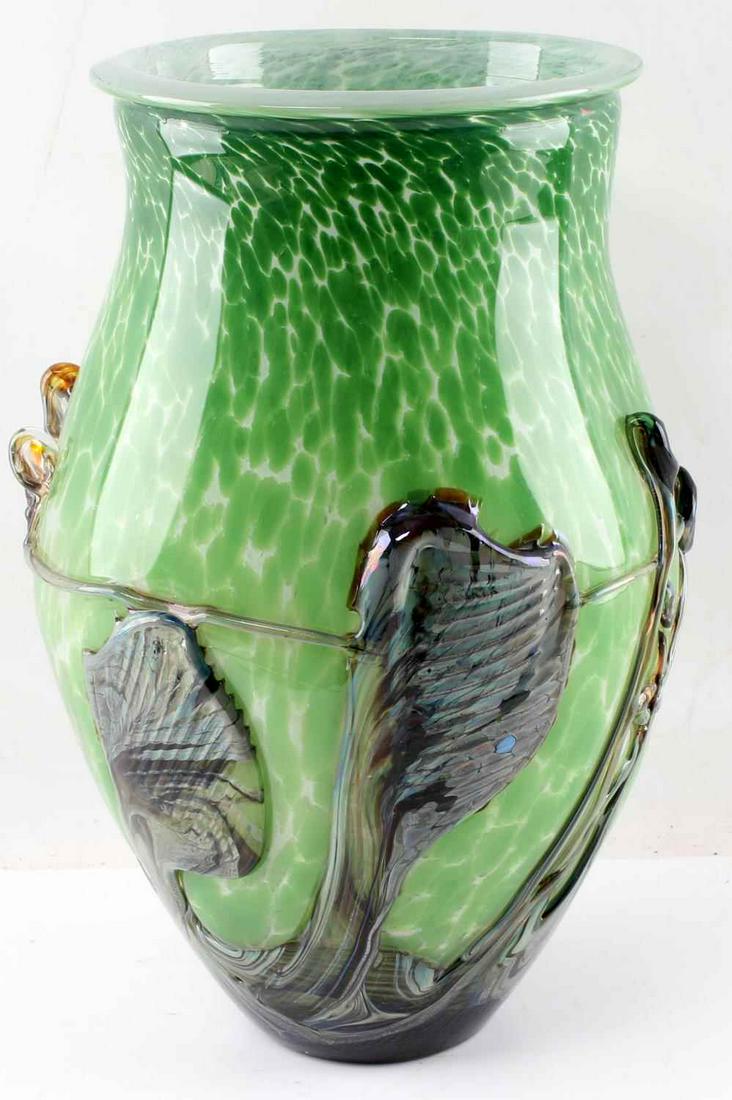 JEAN CLAUDE NOVARO BLOWN ART GLASS LARGE VASE: Jean-Claude Novaro art glass. Blown vase with projecting abstract color splashes against a green ground. Etched signature "Jean Claude Novaro 2010" on base. Jean-Claude Novaro's innovative use of mate
