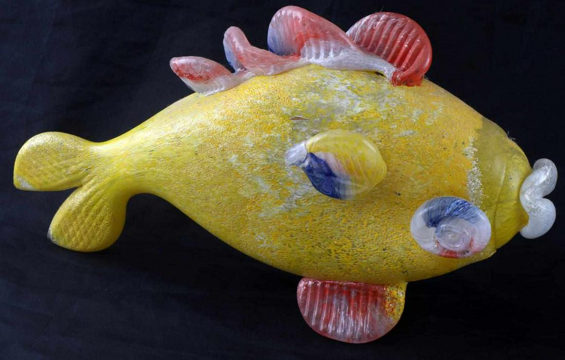 JEAN CLAUDE NOVARO BLOWN ART GLASS YELLOW FISH: Jean-Claude Novaro art glass. Blown glass fish with blue, yellow, and red coloring. Jean-Claude Novaro's innovative use of materials and techniques has cemented his reputation as a master artisan. His