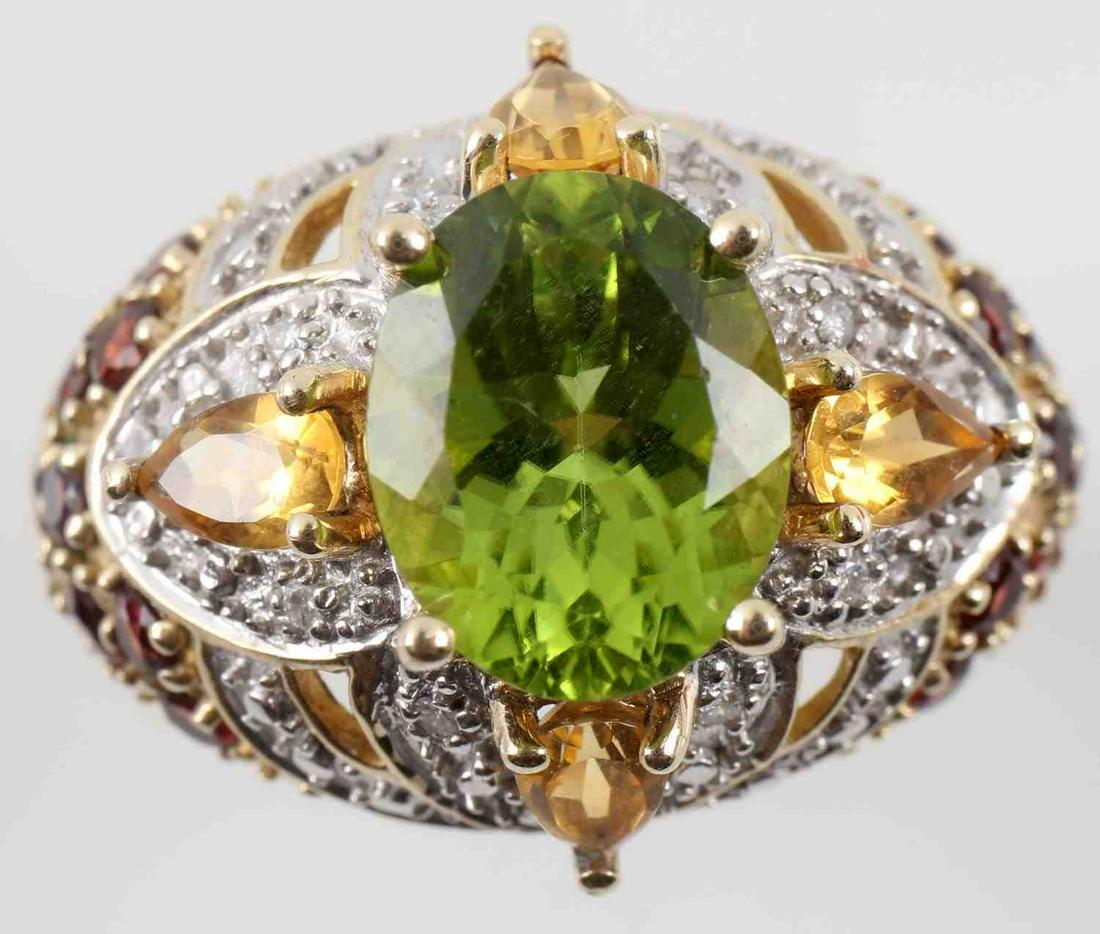 14K GOLD PERIDOT GARNET & CITRINE WOMENS RING: 14k gold ring with oval cut peridot at center. 4 pear cut citrine stones at each side of peridot and 8 round cut garnets at each side of the band. Marked "Thailand" and is size 8. 5.5 grams. This lot 