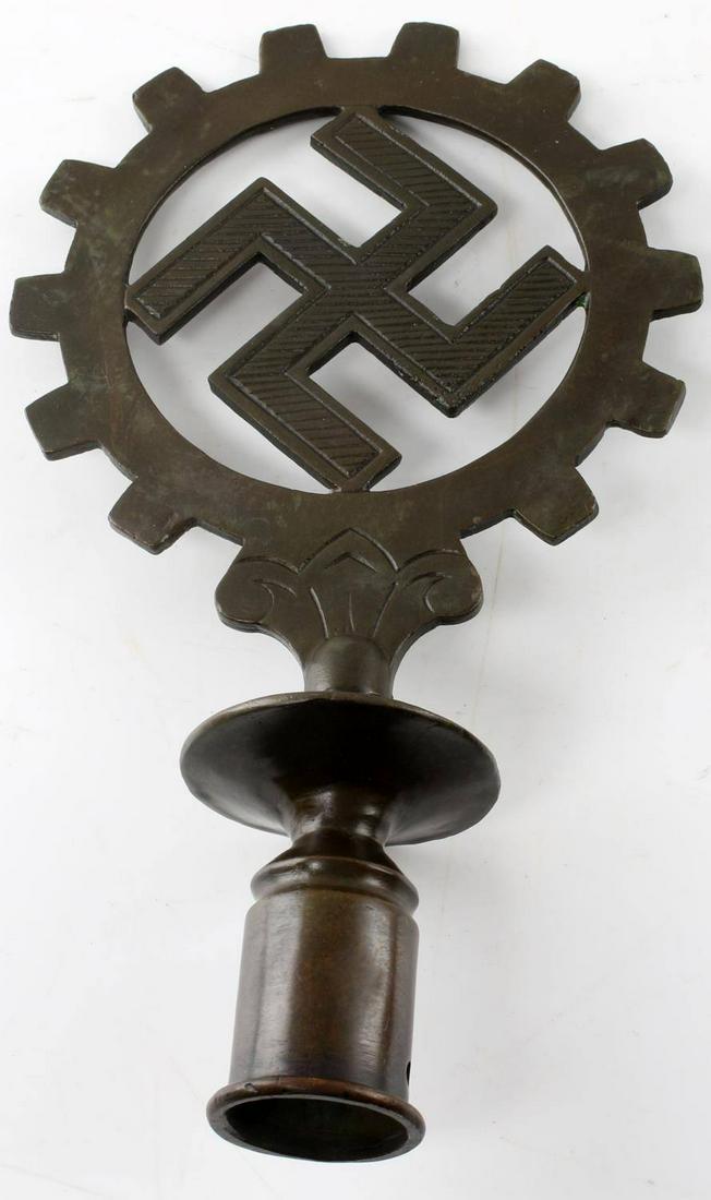 WWII GERMAN THIRD REICH DAF FLAG FINIAL: German DAF flag finial. Brass construction with swastika and DAF (German Labor Front) cogwheel. Measures 9.5" tall. Very good condition overall. Some wear and signs of abrasions present.