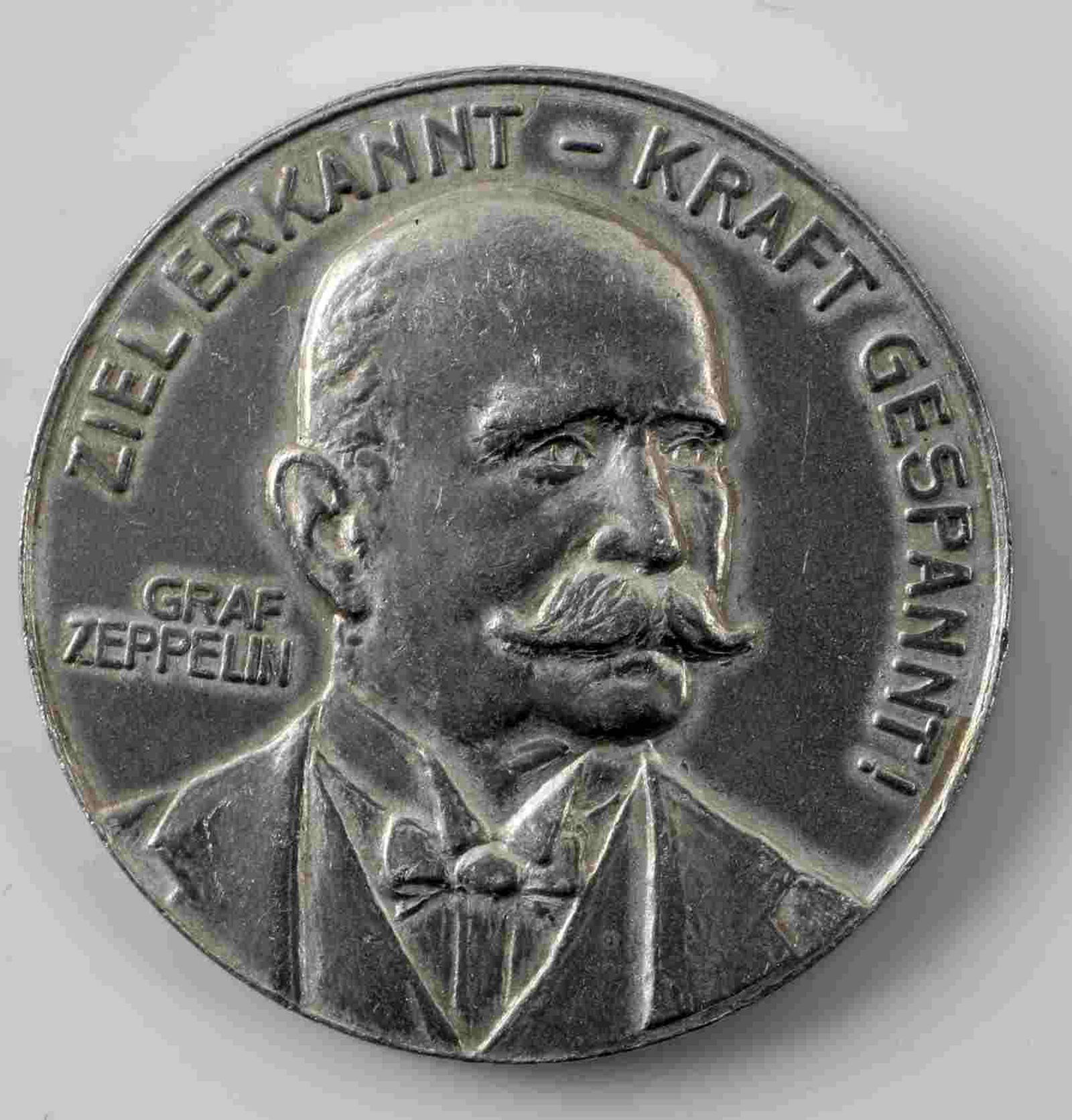 IMPERIAL GERMAN 1908 GRAF ZEPPELIN TABLE MEDAL: 1908 Table medal featuring the Graf von Zeppelin on the obverse while the reverse features an airship. Measures 1 5/16 inches in diameter. Aluminum construction. In very good condition.