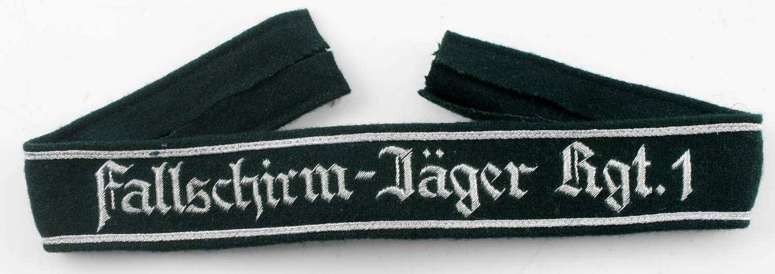 WWII GERMAN FALLSCHIRMJAGER PARATROOPER CUFF TITLE: German Fallschirmjager Regiment 1 officer's cuff title. Silver bullion wire and green wool construction. Measures 18 5/8" X 1 3/8". Excellent condition overall. Unauthenticated; sold as is. Stitching 