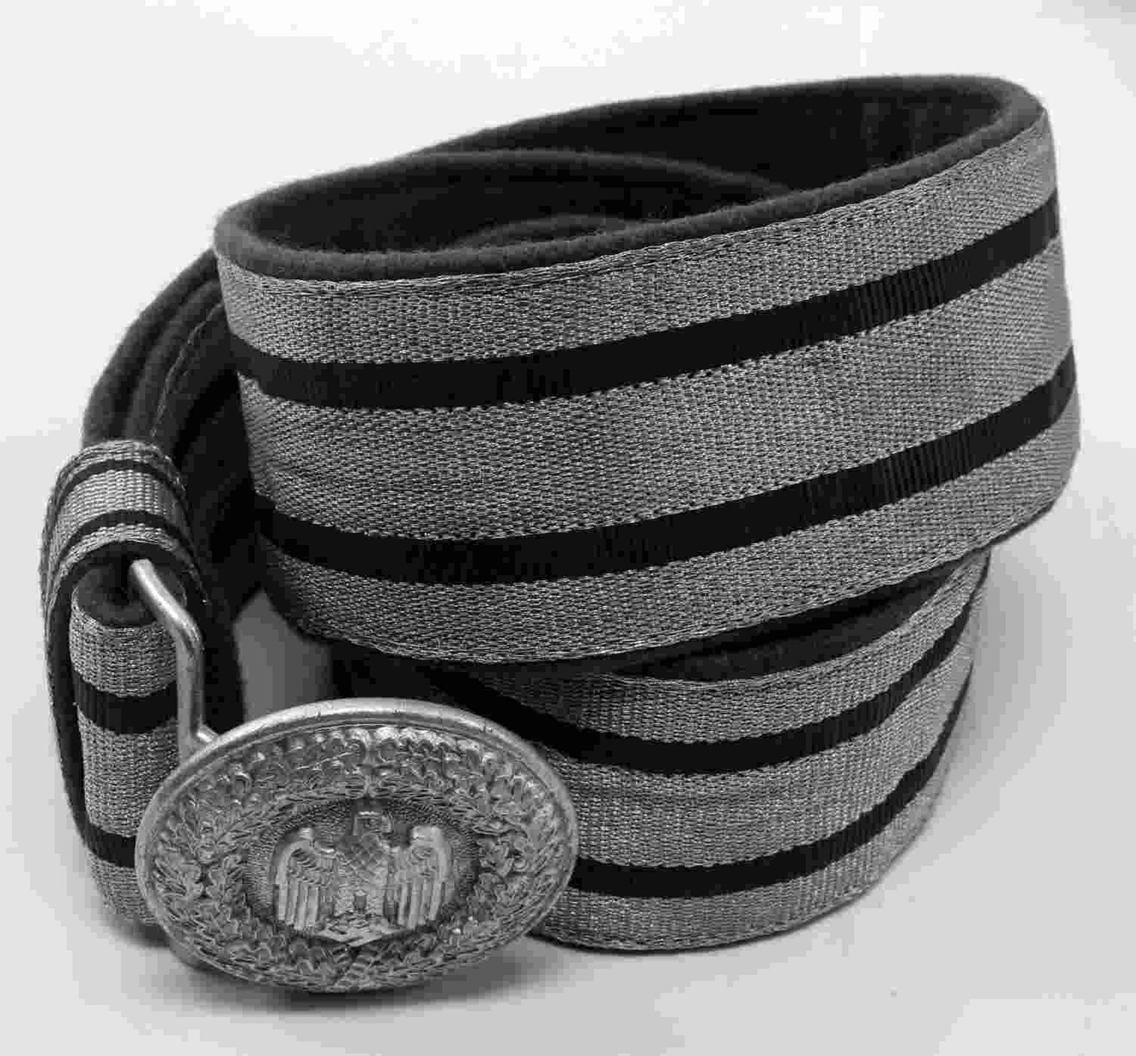 WWII GERMAN THIRD REICH ARMY OFFICER BELT & BUCKLE: Dress brocade belt and buckle of a German Army officer. Reverse of buckle is marked 'A' for Assmann manufacturing firm. Two-piece stamped aluminum construction. Belt is flat bullion wire brocade and m