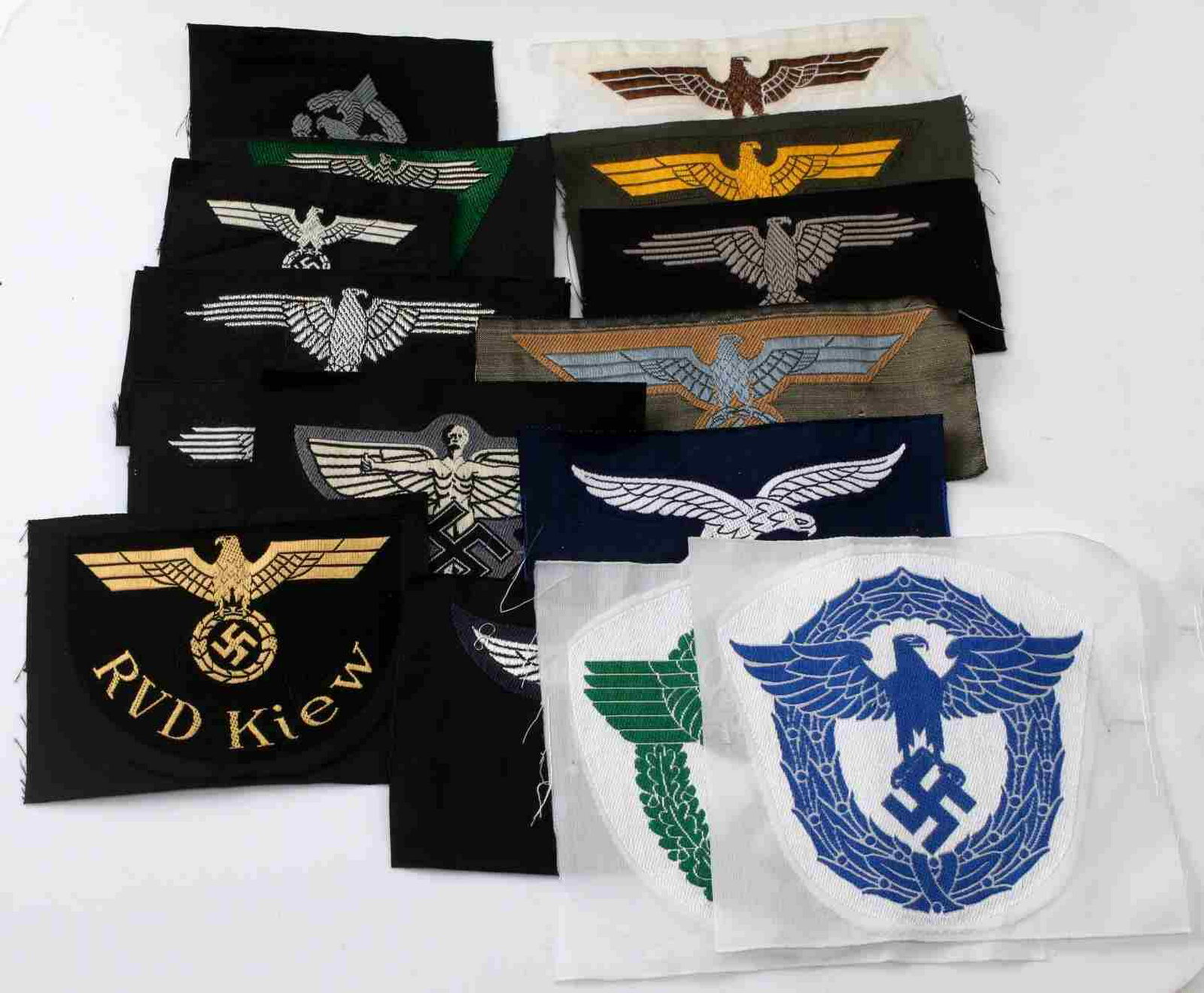 WWII GERMAN THIRD REICH CLOTH INSIGNIA LOT OF 15: German cloth insignia lot. Includes police, Waffen SS, Afrika Korps, Coastal Artillery, Army Panzer, SS police, Luftwaffe Enlisted, NSFK, Luftwaffe Officer, and more. Machine embroidered cloth constru