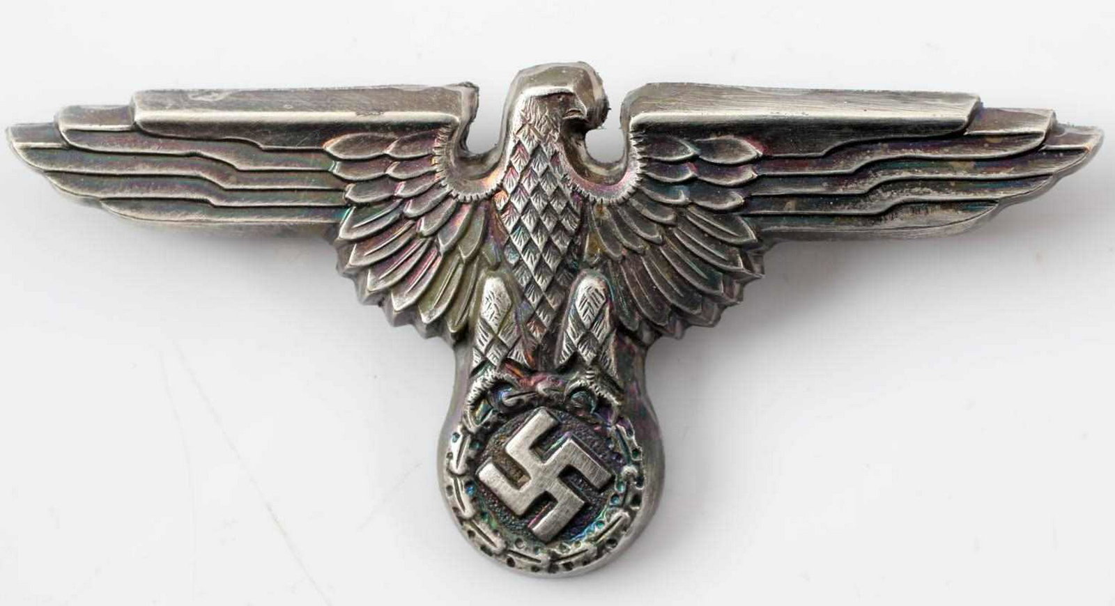 WWII GERMAN THIRD REICH SS OFFICER VISOR CAP EAGLE: Reichsadler from the visor cap of an SS officer. Reverse is maker marked 'RZM M1/14'. Has two flat horizontal prongs crimped in place on the back. Stamped nickel construction. In very good condition. 