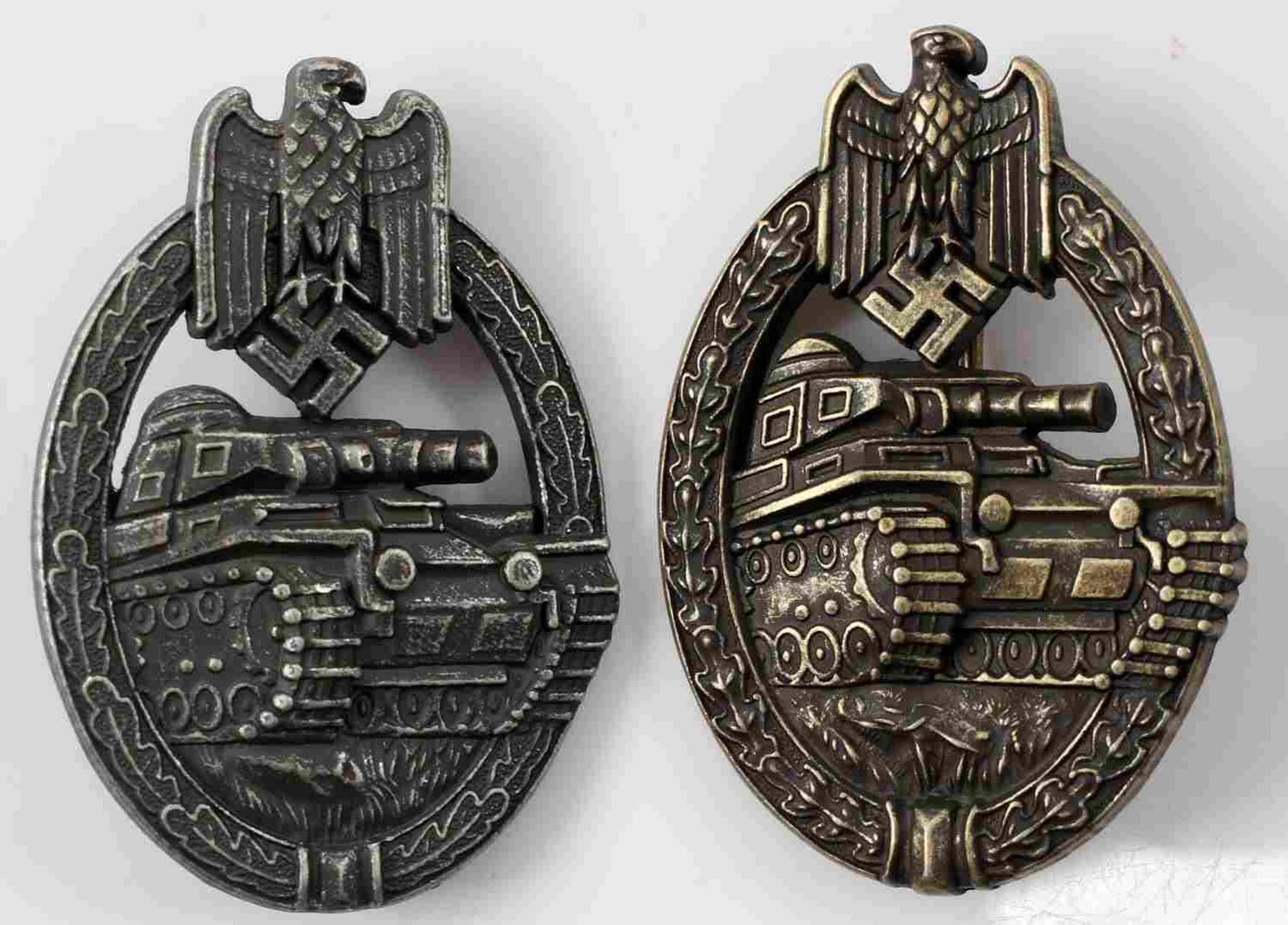 WWII GERMAN THIRD REICH PANZER ASSAULT BADGE LOT: German Panzer Assault badges in bronze and silver. Both are solid back versions and have thin vertical pin backs. Bronze version is maker marked I over A on its reverse and silver version is marked "A