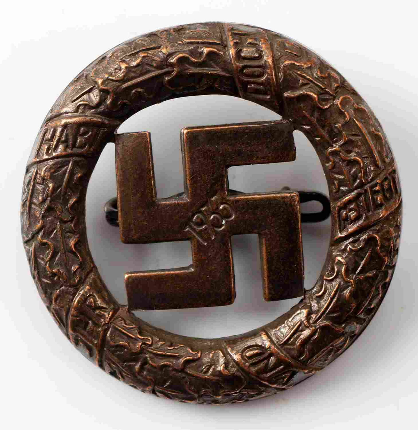 WWII GERMAN GAU MUNCHEN BLOOD ORDER BADGE: German 2nd model Blood Order badge. Measures 1 3/8 inches in diameter. Reverse maker marked Deschler & Sohn Munchen. Has a thin horizontal pin back. Stamped copper construction. Excellent condition.