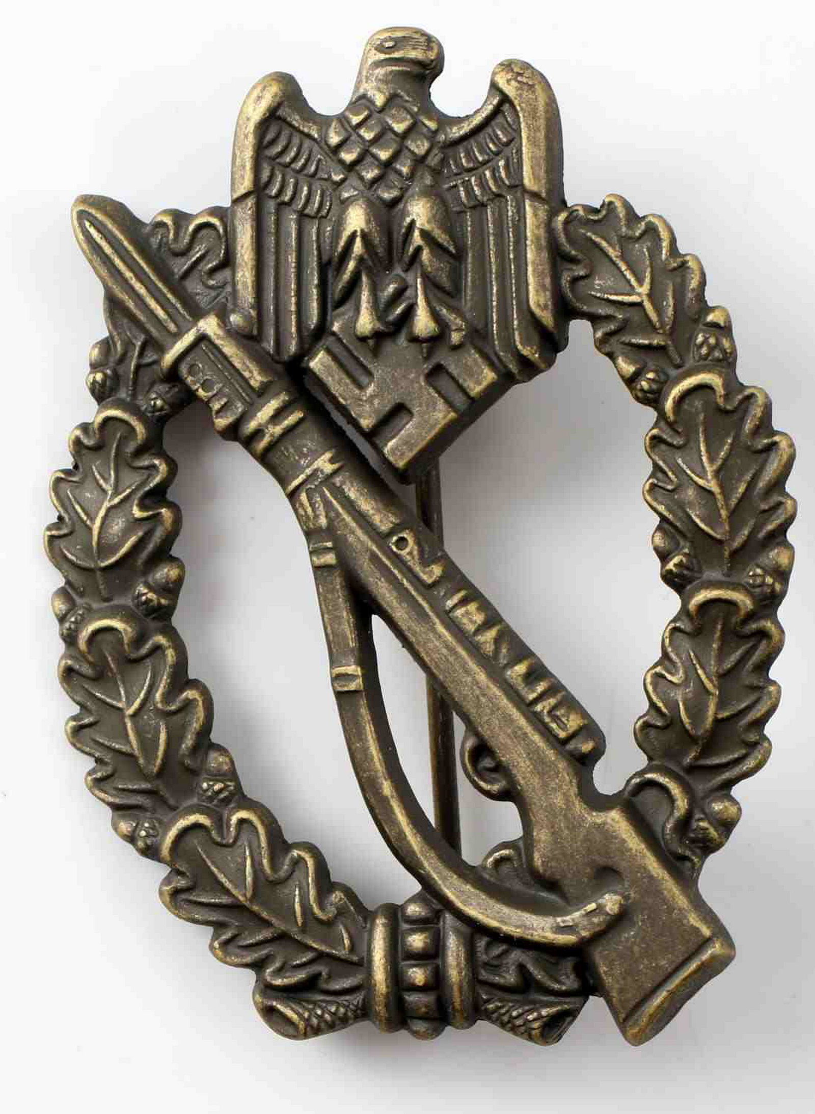 WWII GERMAN ARMY BRONZE INFANTRY ASSAULT BADGE: The front has a Mauser K-98 rifle to center with an army eagle above. Reverse is marked 'S H u Co 41.' Thin vertical pin back. Bronze construction. Unauthenticated sold as is.