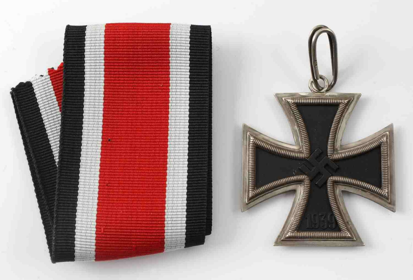 WWII GERMAN THIRD REICH KNIGHTS CROSS IRON CROSS: Knights Cross of the Iron Cross. Maker marked 'L/12' for maker CE Junker on the reverse of the upper arm. It is also marked '800' for the silver content. Suspension loop is also marked '800'. Three pi