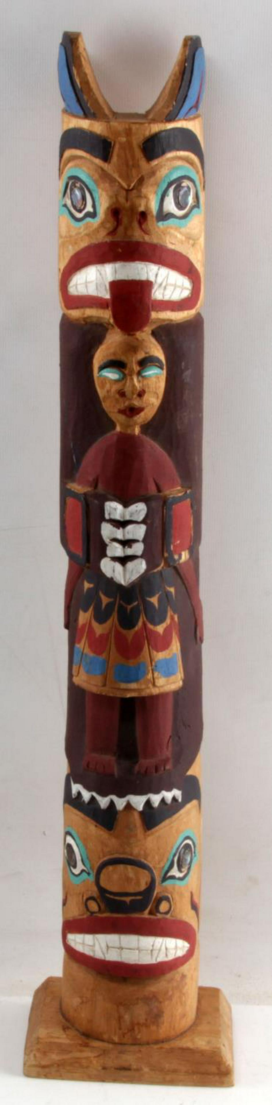 PACIFIC NORTHWEST HAND CARVED SMALL TOTEM POLE: Depicts two mask faces and human figure to center, abalone eyes, marked to back 'Bear Mother' and 'Black Bear.' Stands 22.5 inches tall. Very good condition.